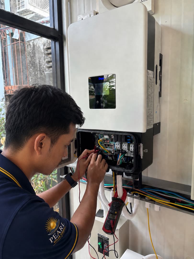 Technician commissioning and testing a solar inverter